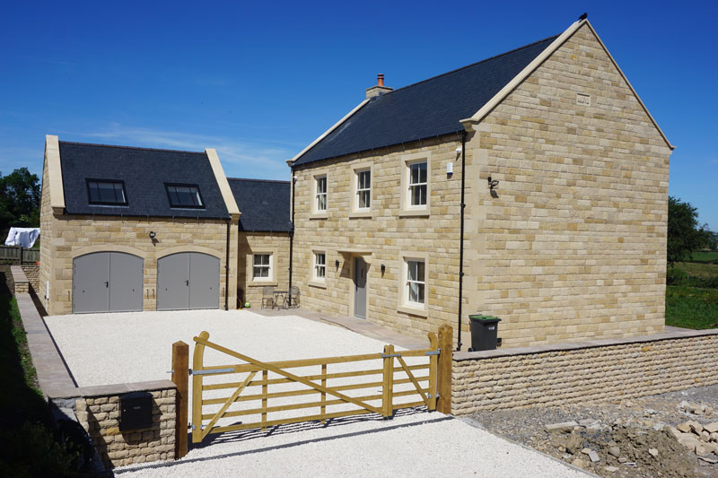 This traditional stone-clad farm house is built of SIPs